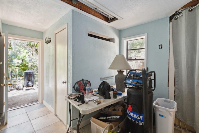 tiled office featuring a textured ceiling