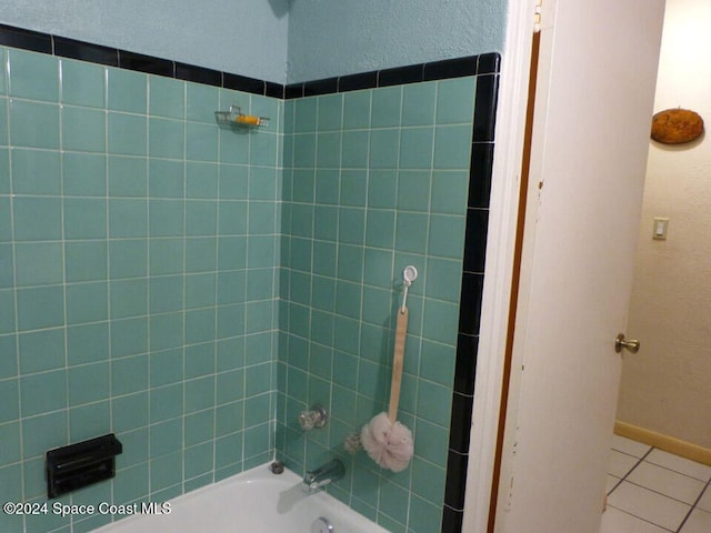 bathroom featuring tile patterned floors and tiled shower / bath