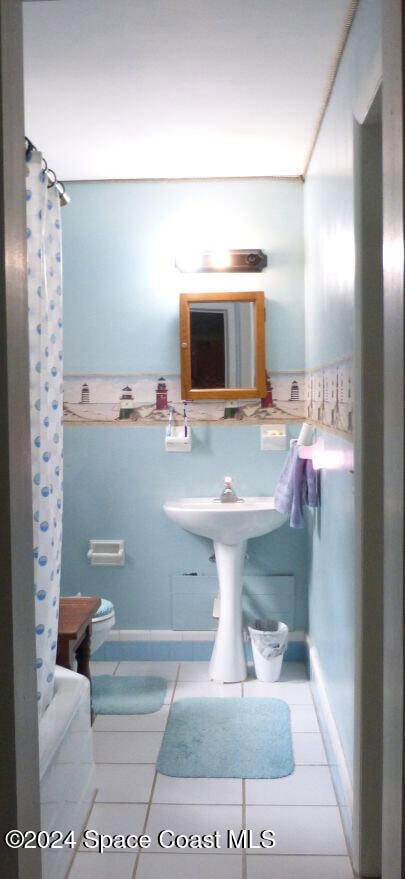 bathroom featuring walk in shower and tile patterned floors