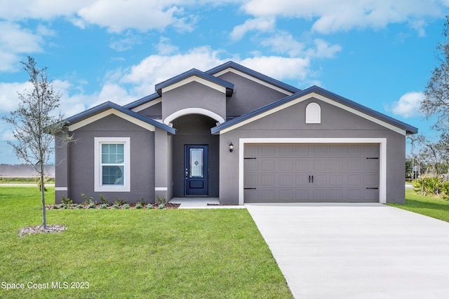 ranch-style house featuring a front lawn and a garage