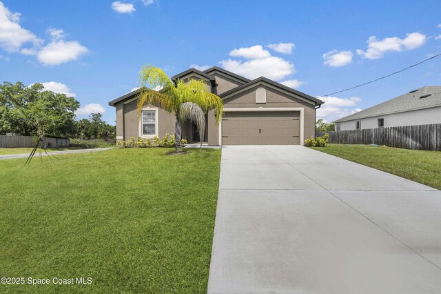 2498 Fleming Ave SW, Palm Bay, FL 32908 - view of front of property with stucco siding, an attached garage, and concrete driveway
