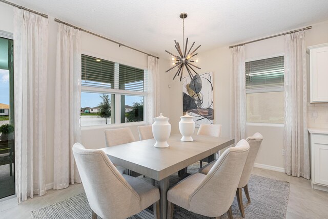 tiled dining area with an inviting chandelier