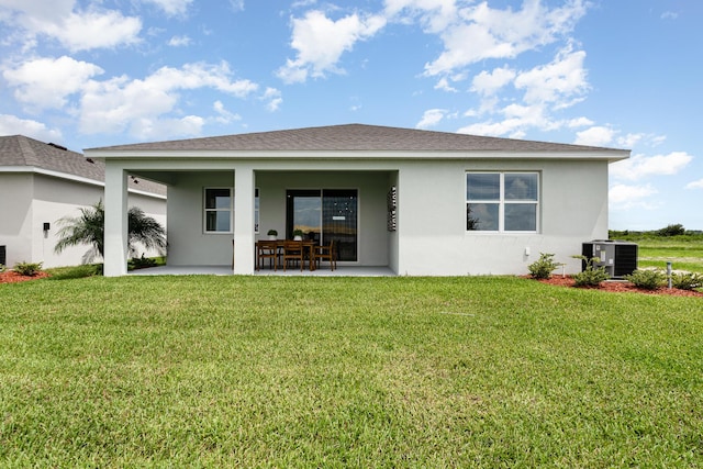 back of property featuring central AC, a patio, and a lawn