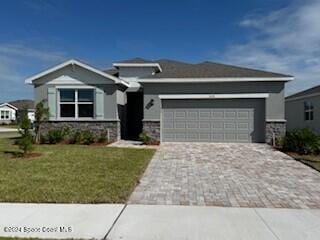 view of front of property with a garage and a front yard