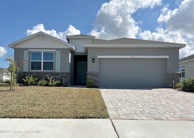 view of front of property with a garage and a front lawn