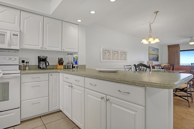 kitchen with kitchen peninsula, white appliances, pendant lighting, light tile patterned floors, and white cabinets