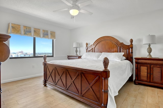 bedroom with light wood-type flooring and ceiling fan