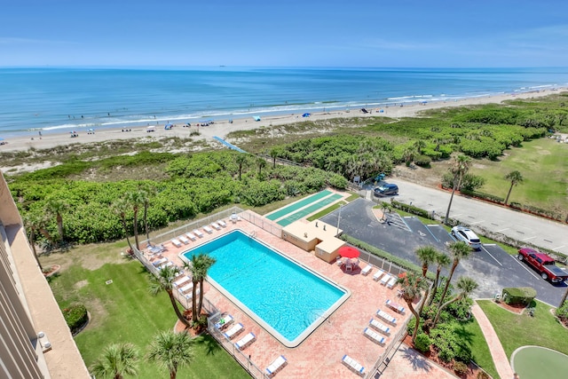 drone / aerial view featuring a water view and a beach view