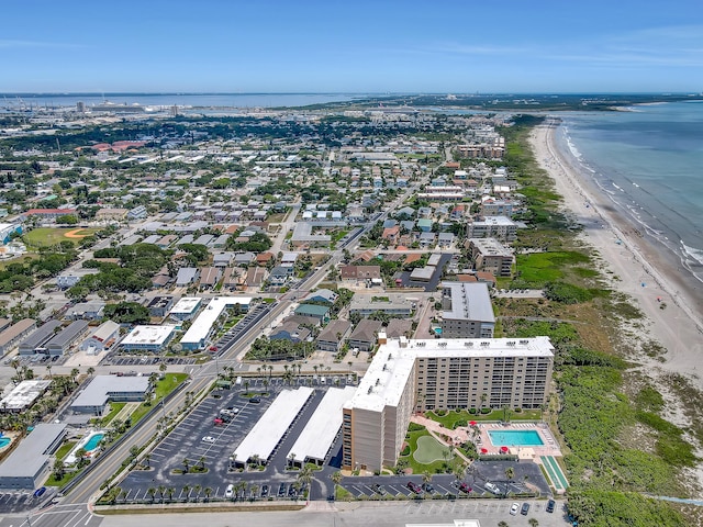 birds eye view of property with a water view and a view of the beach