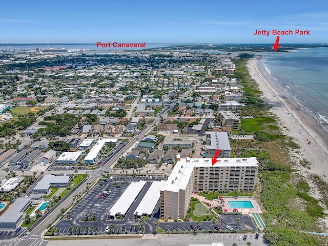 drone / aerial view featuring a water view and a view of the beach