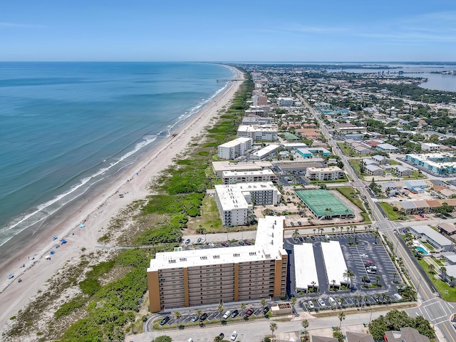 birds eye view of property featuring a beach view and a water view