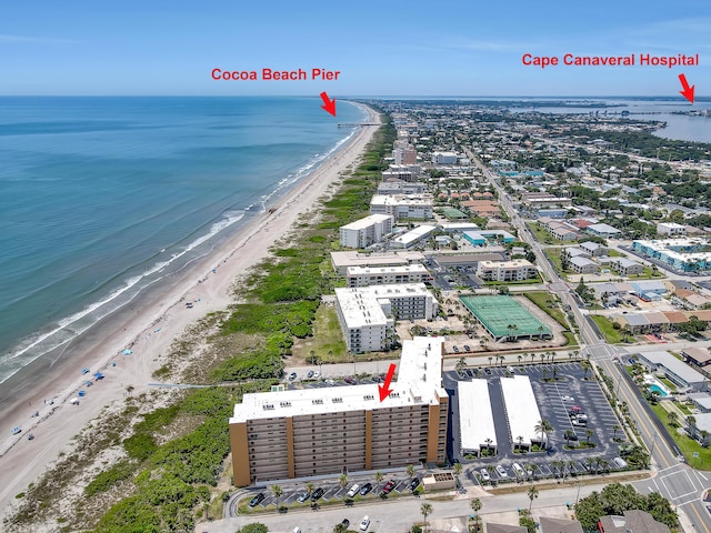 birds eye view of property with a view of the beach and a water view