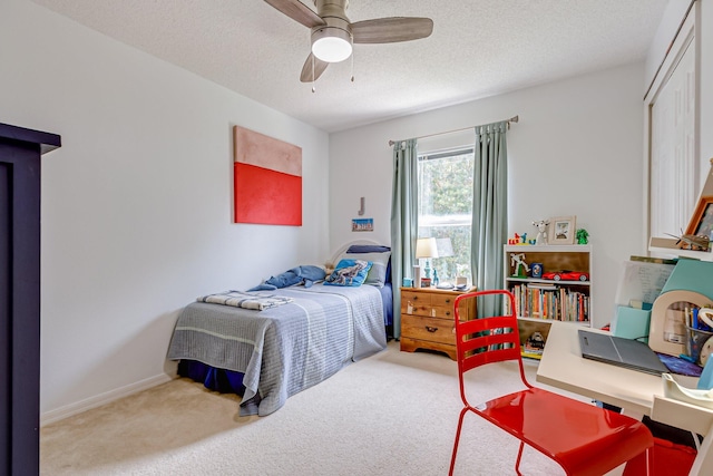 bedroom with carpet, ceiling fan, a textured ceiling, and a closet