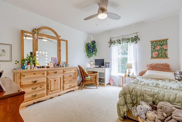 bedroom featuring ceiling fan, carpet floors, and a textured ceiling