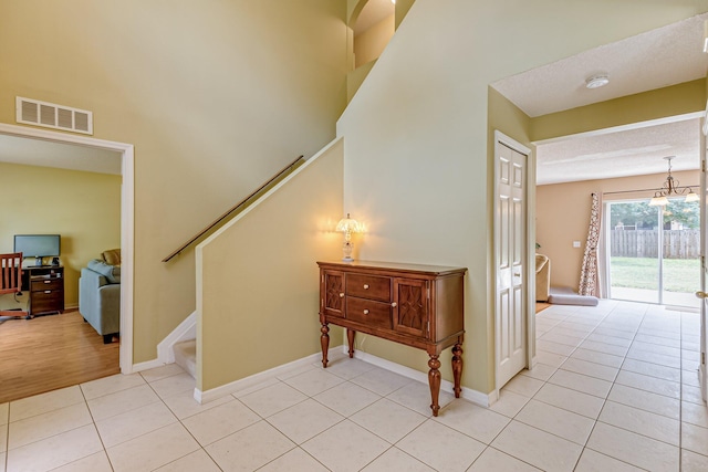 staircase with tile patterned floors and a textured ceiling