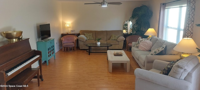 living room with light hardwood / wood-style floors and ceiling fan