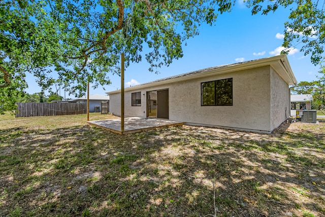 rear view of house with central air condition unit and a patio