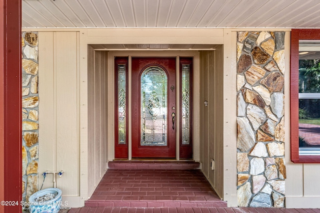 property entrance with stone siding