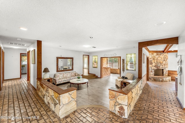 living room featuring a fireplace and a textured ceiling