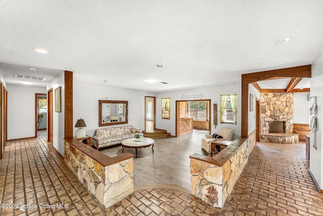 living area with baseboards, brick floor, recessed lighting, and visible vents
