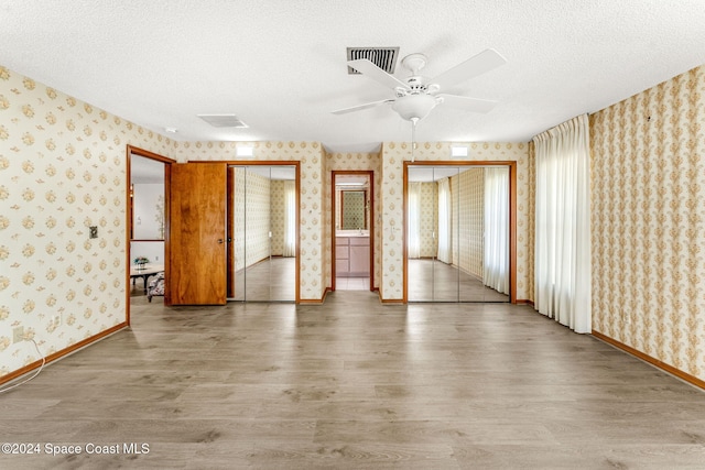 spare room featuring hardwood / wood-style floors, a textured ceiling, and ceiling fan