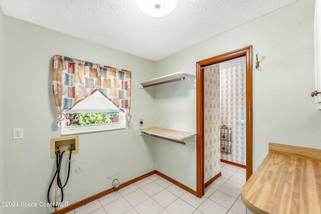 washroom featuring hookup for an electric dryer, a textured ceiling, and washer hookup