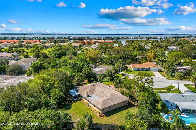 drone / aerial view with a water view and a residential view