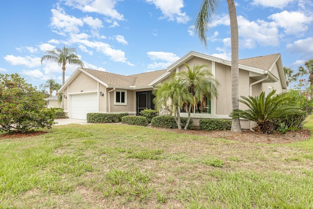 single story home featuring a garage and a front yard