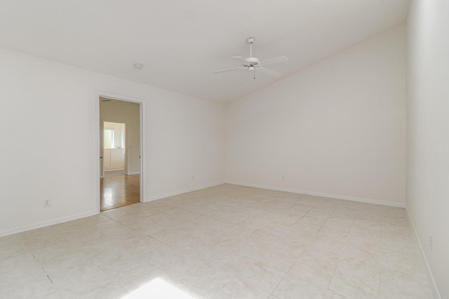 empty room featuring ceiling fan and vaulted ceiling