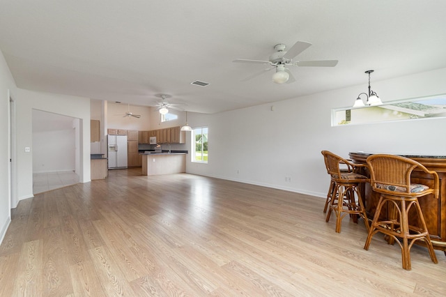 interior space with an inviting chandelier and light hardwood / wood-style flooring