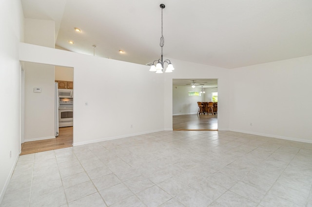 unfurnished room featuring lofted ceiling, ceiling fan with notable chandelier, and light tile patterned flooring