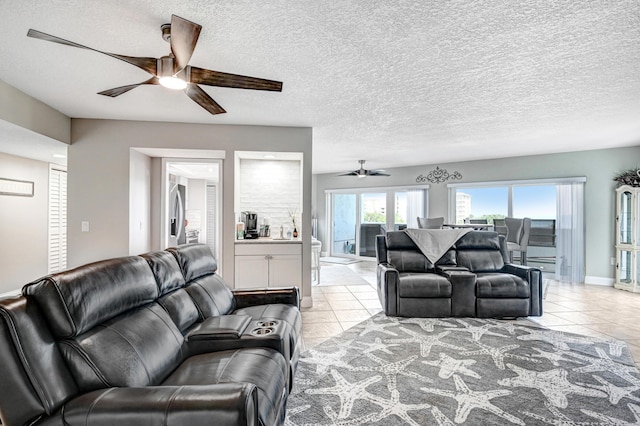 tiled living room featuring ceiling fan and a textured ceiling