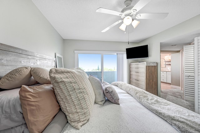 bedroom with access to exterior, a textured ceiling, and ceiling fan