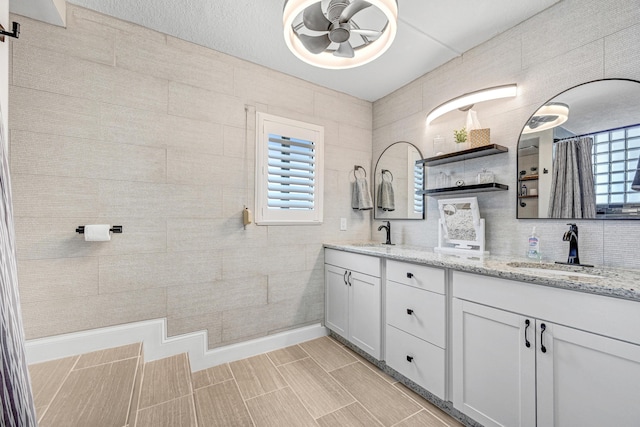 bathroom featuring vanity, ceiling fan, and decorative backsplash