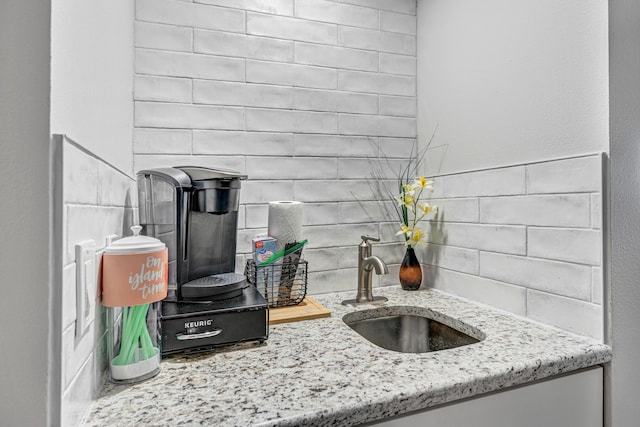 room details with vanity, wet bar, and decorative backsplash