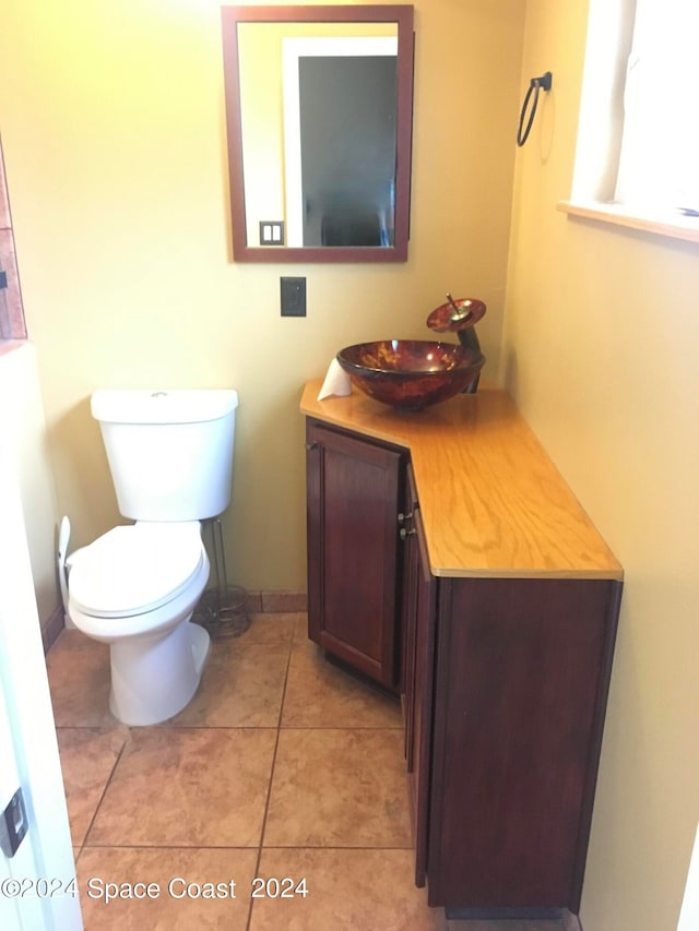 bathroom with vanity, toilet, and tile patterned floors