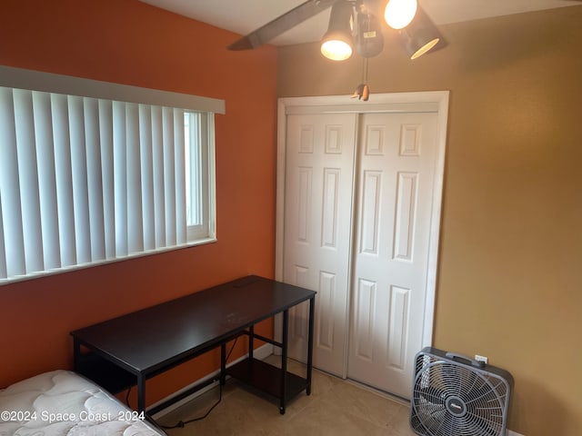 tiled bedroom with a closet and ceiling fan