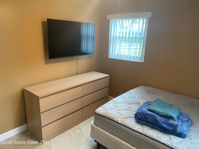 bedroom featuring light tile patterned flooring