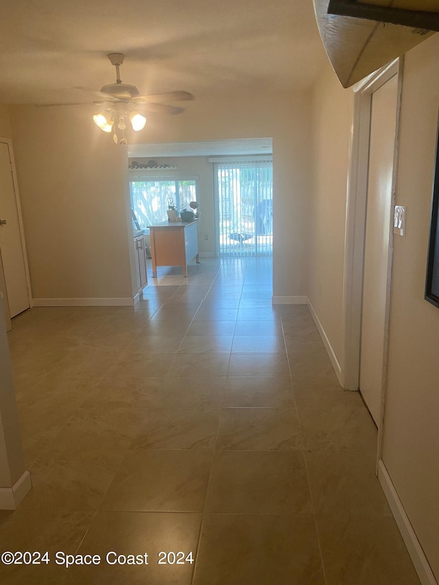 hallway with tile patterned flooring