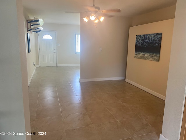 interior space with ceiling fan and light tile patterned flooring