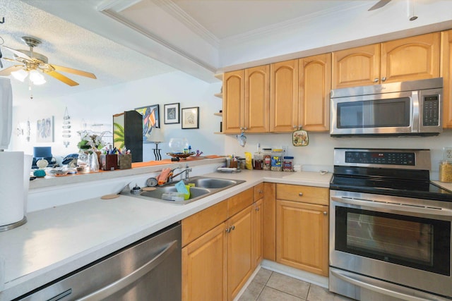 kitchen with light tile patterned flooring, sink, ornamental molding, ceiling fan, and stainless steel appliances