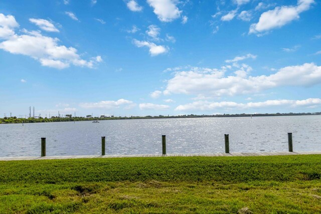 view of dock featuring a yard and a water view