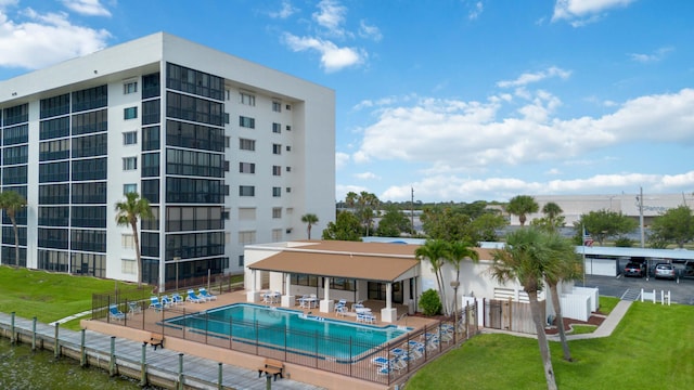 view of swimming pool with a patio and a lawn