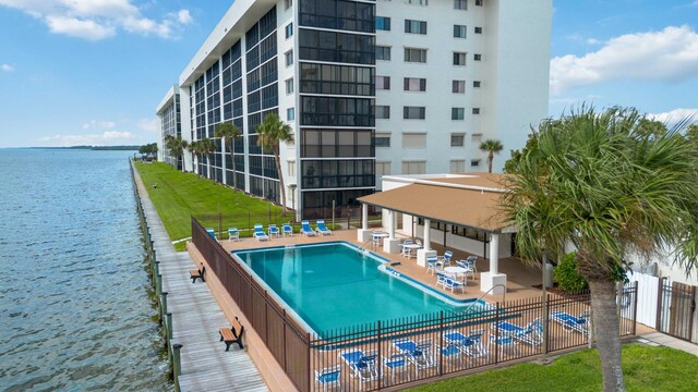 view of pool with a water view, a patio area, and a gazebo