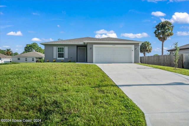 single story home with a garage and a front yard