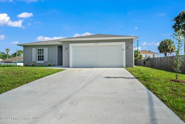 ranch-style home with a front yard and a garage