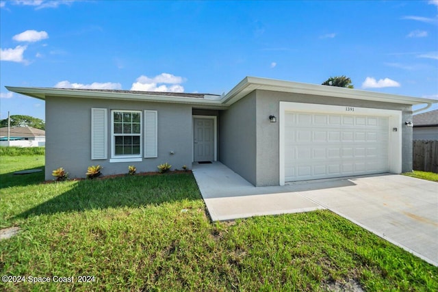 ranch-style home with a front yard and a garage