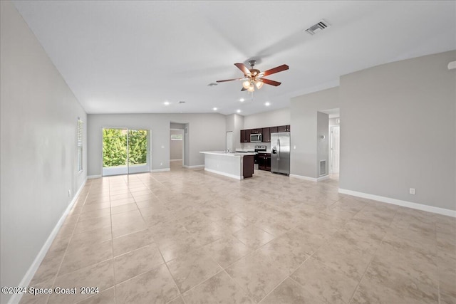 unfurnished living room featuring light tile patterned flooring and ceiling fan