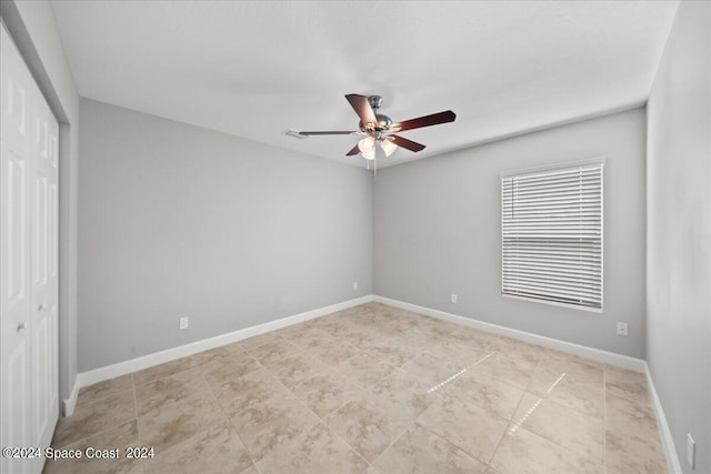 unfurnished room with ceiling fan