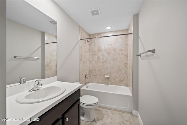 full bathroom featuring toilet, vanity, and tiled shower / bath